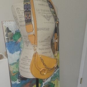 Stylish Mustard Saddle Crossbody Bag with Interchangable Decorative Straps.